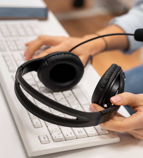 woman-working-call-center-holding-pair-headphones